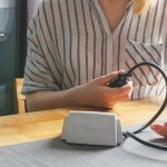 woman holding a blood pressure monitor